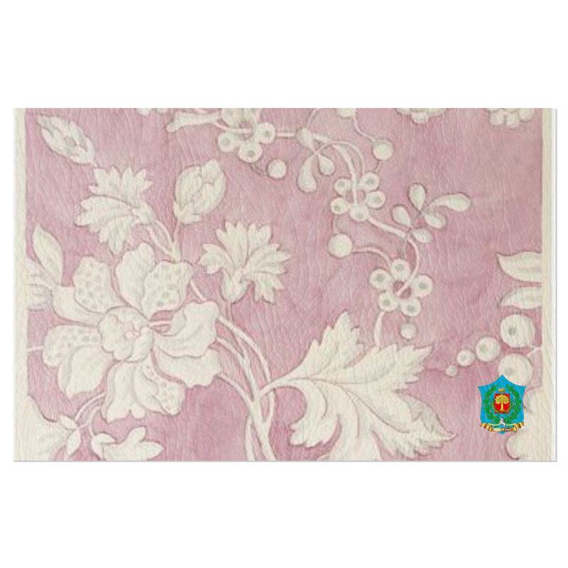 The pink leather texture features white, intricate floral and leaf patterns, with a colorful shield emblem in the bottom right corner. These handmade-to-order FeelGood Breakfast designs add unique flair and elegance to your table.