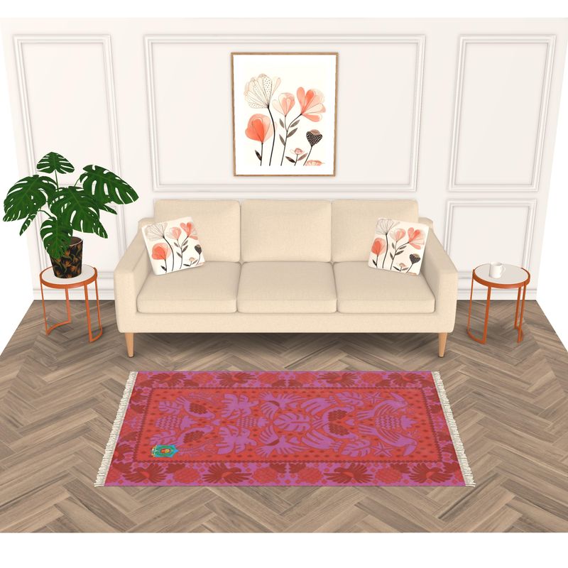 A modern living room features a beige sofa with floral cushions, a plant to the left, and round side tables with candles. A handmade floral artwork is above, and a vibrant red and purple velvet-patterned Rug enhances the herringbone floor.