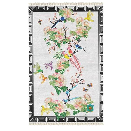 The handmade Rug features a black geometric border adorned with colorful birds and intricate flowers in pink, green, and yellow on a light background, offering a velvet-like texture for added luxury.