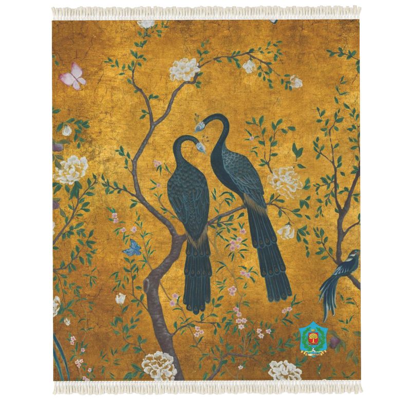 A handmade tapestry/rug depicting two blue peacocks on a branch among white flowers and greenery against a golden background, with a nearby butterfly. It features an anti-slip base for enhanced functionality.