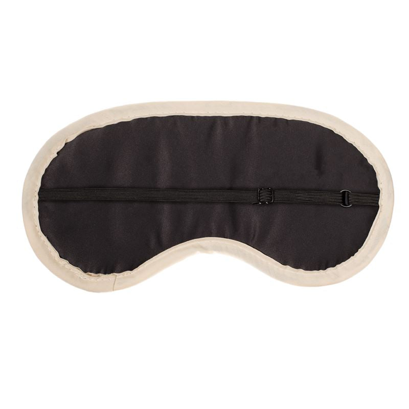 The FeelGood Sleep mask is a luxurious designer item featuring a black exterior, beige trim, and quilted cushion padding for ultimate comfort. Made from soft satin fabrics, it has an adjustable strap for a perfect fit.