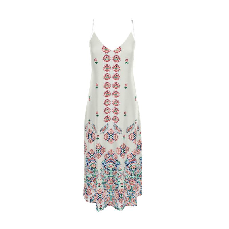 The Hello, World! dress is a white maxi with thin straps, featuring a vibrant floral and geometric pattern. It blends pink and blue hues in vertical lines on its charming fabric, enhanced by ornate motifs at the flared bottom for a bohemian style.