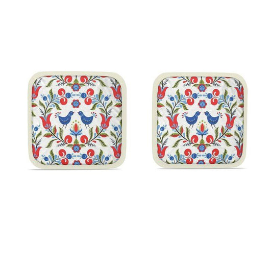 Lullaby of Birdland - Designer Pot Holder Set – Handmade, Heat-Resistant, Dual-Use with folk-art bird and floral pattern in red, blue, and green. Set of 2 with cream trim.