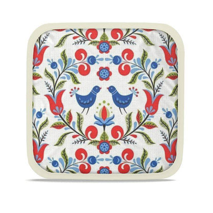 Lullaby of Birdland - Designer Pot Holder Set – Handmade, Heat-Resistant, Dual-Use with folk-art bird and floral pattern in red, blue, and green. Set of 2 with cream trim.